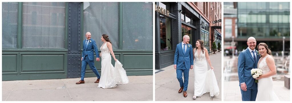 A couple in wedding attire exchange glances and walk hand in hand along the streets of Denver for a Denver wedding photographer