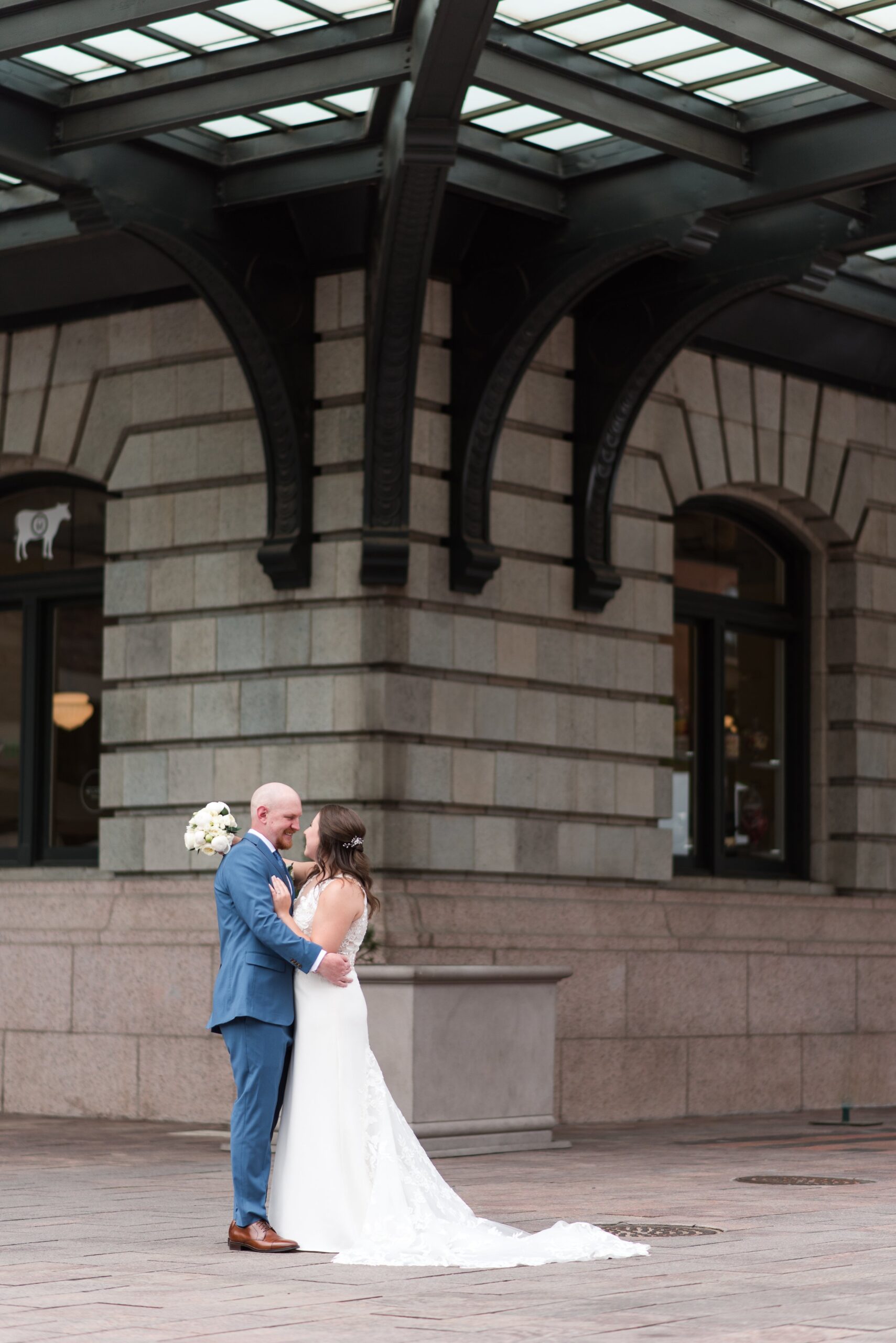 Denver wedding photographer captures a couple embracing under an awning at union station