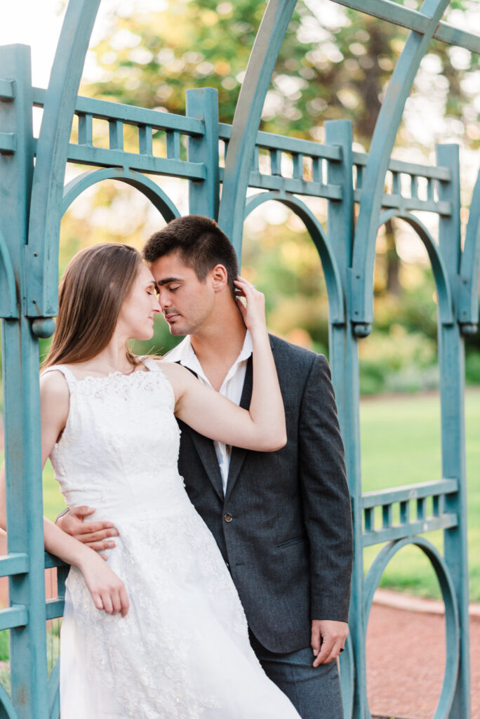 Two young people under a green bridge Colorado springs wedding photographers