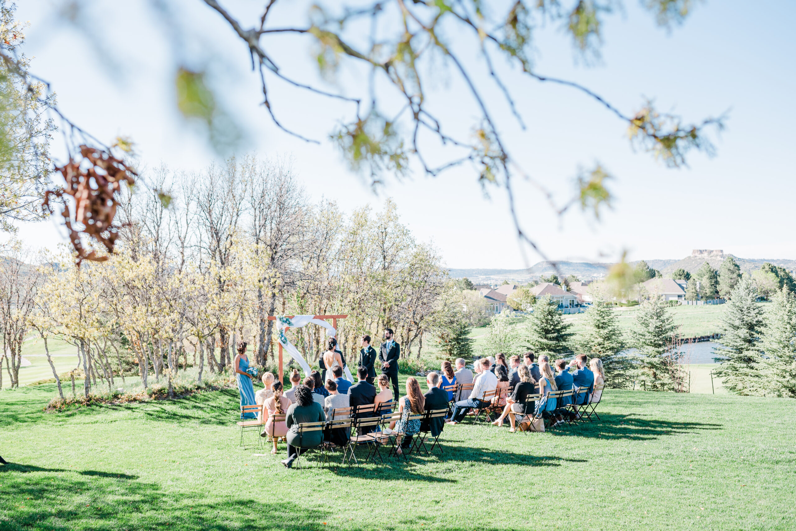 Zoomed out photo of the outdoor ceremony space near scrub oak at The Oaks wedding venue in Castle Rock