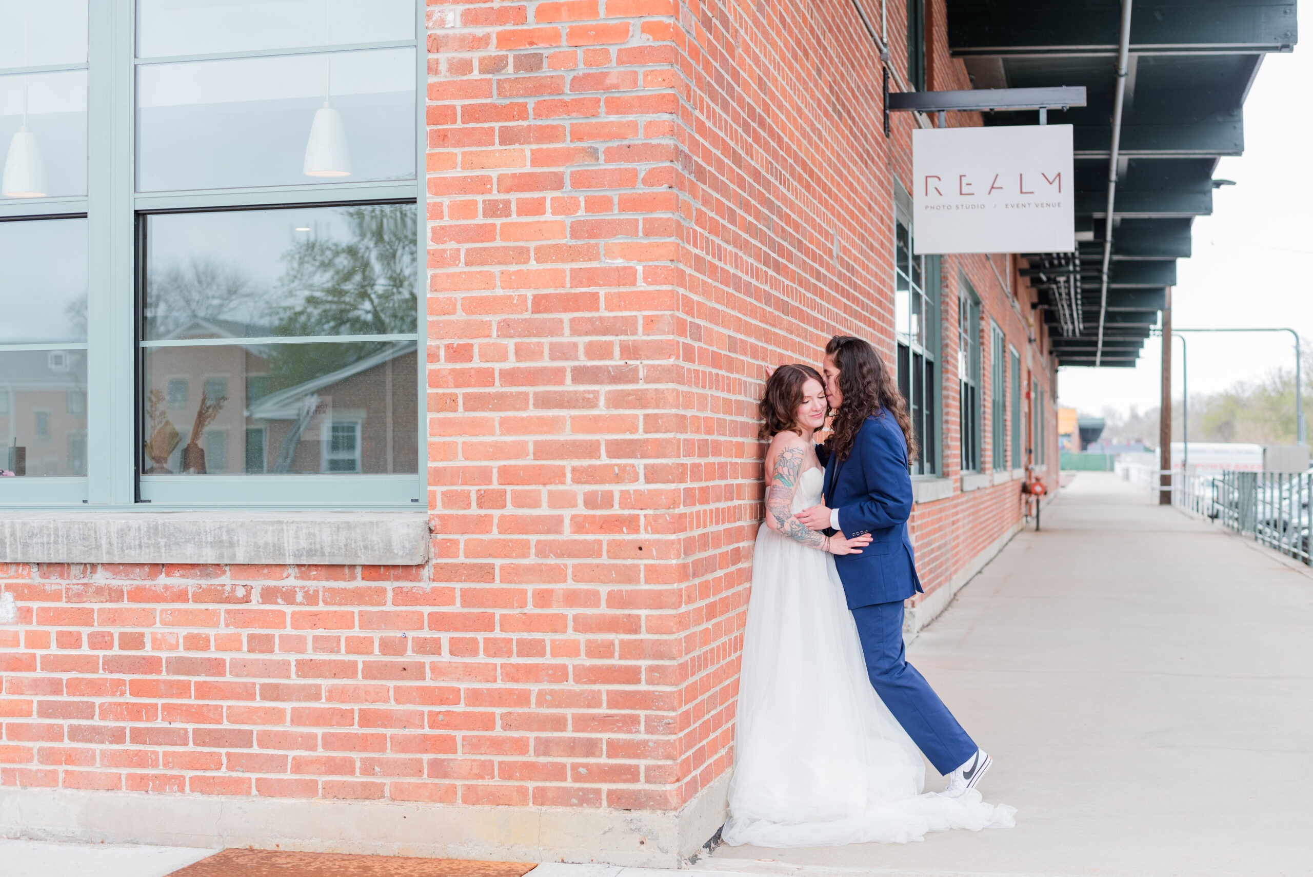 Couple leans up against wall at one of the top wedding venues in Denver called Realm Denver